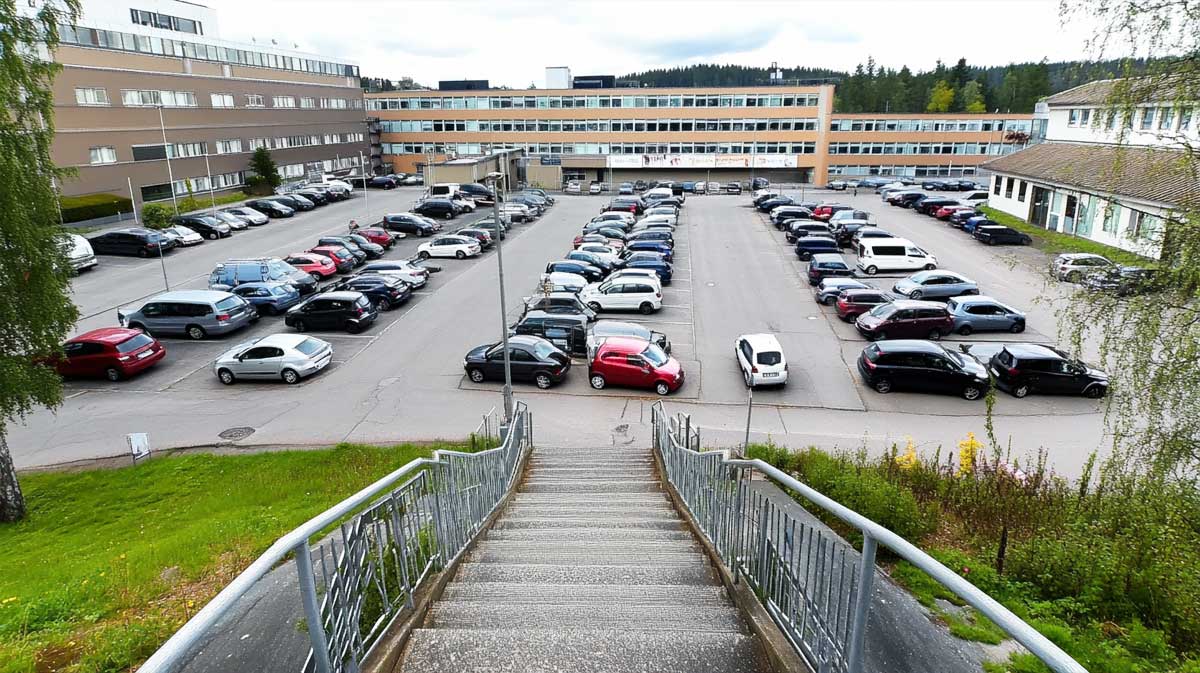 parkings hospitaliers : voiture garée devant un hôpital avec un horodateur en avant-plan